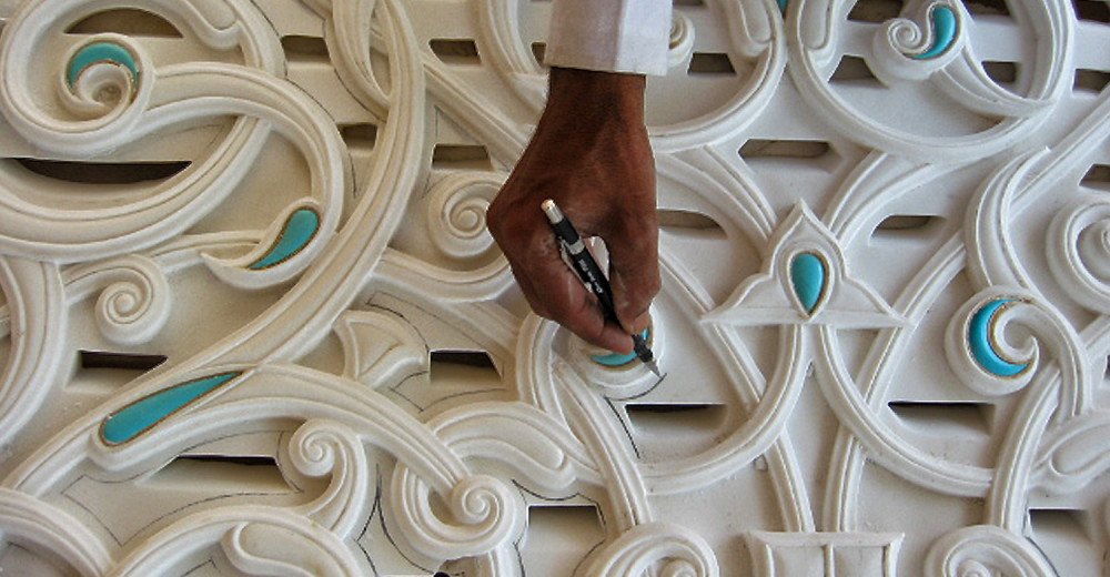 An image showcasing the intricate Jali work in marble art, skillfully crafted by a master artisan