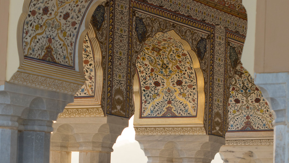 Discover the allure of Jal Mahal Water Palace, Jaipur, India, with an image showcasing intricate Mughal carving on its pillars